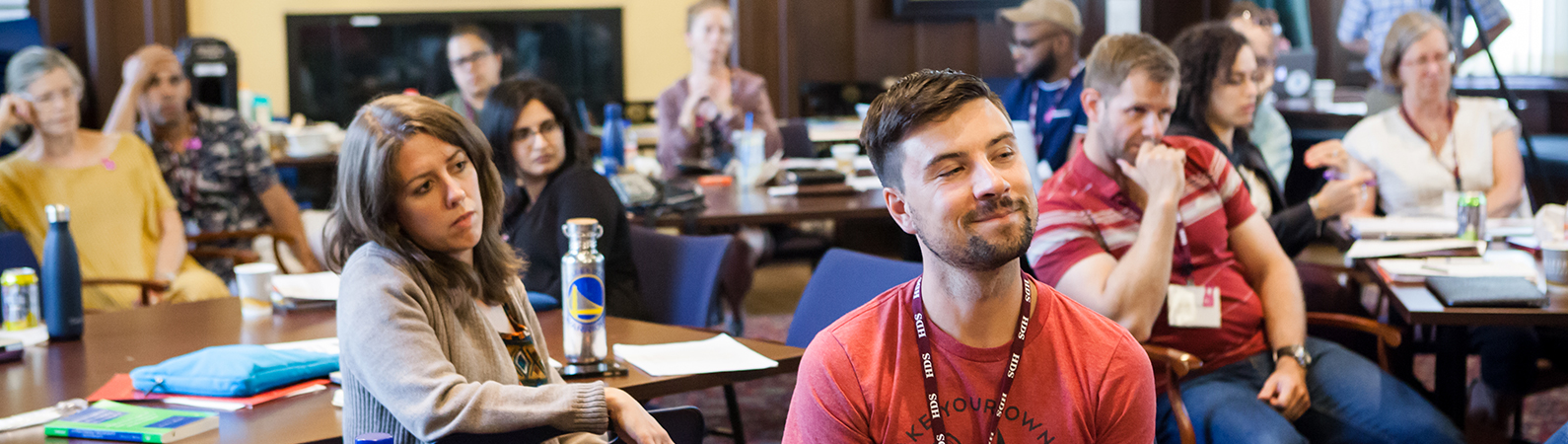 Students seated at tables in the Braun Room during the 2018 Summer Institute