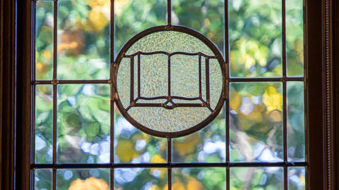 Stained glass book image in a window
