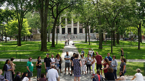 Students gathered outside the Memorial Church in Harvard Yard with Widener library in the background