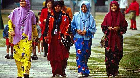 Members of Sisters in Islam walking down a street