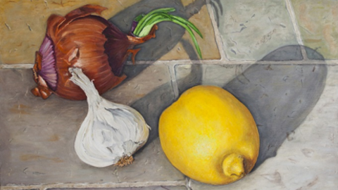 Art piece featuring a lemon, head of garlic, and onion