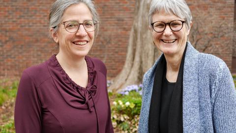 Dr. Cohn and Dr. Moore in front of a large tree outside