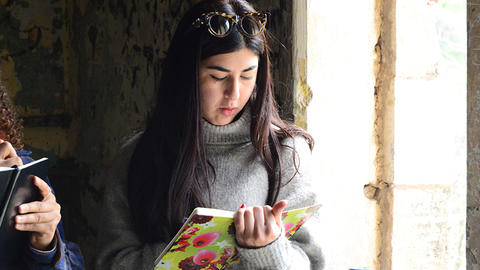 Student at a historic site, writing in a notebook