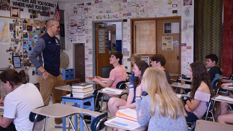 Teacher at the front of a high school class