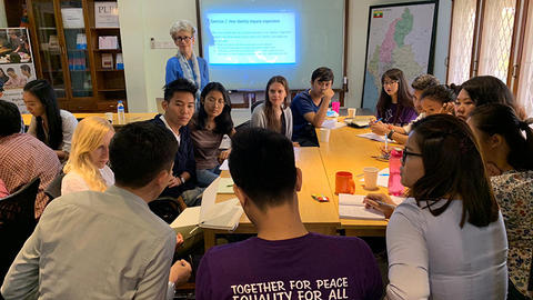 High school classroom full of students and a teacher