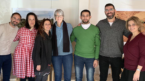 Seven Religion and Public Life fellows and staff members, arm in arm, pose for a group photo.