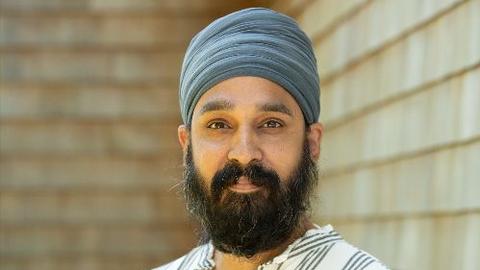 Simran Jeet Singh holds his book "The Light We Give."