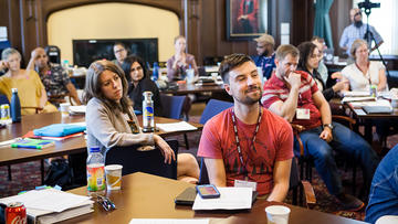 Students seated at tables in the Braun Room during the 2018 Summer Institute