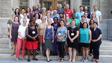 Group shot of Summer Institute participants on the steps of Swartz Hall