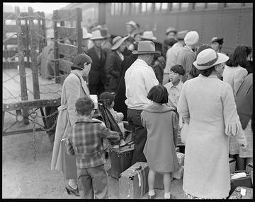 Families in line at a train station