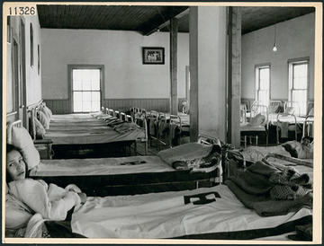 Dormitory beds with several girls lying on them