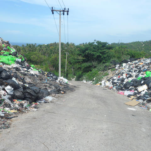 Huge piles of trash on both sides of a road