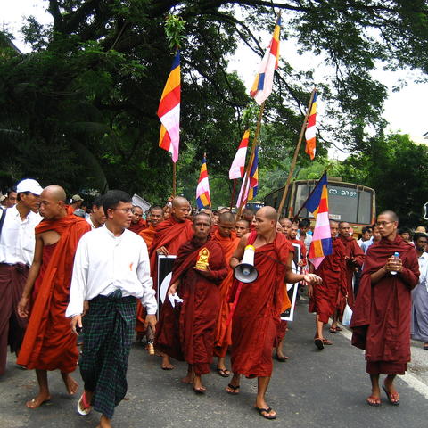Monks with flags and megaphones marching in protest