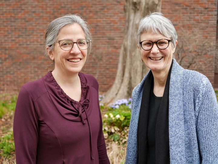 Dr. Cohn and Dr. Moore in front of a large tree outside