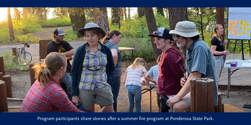 Program participants share stories after a summer fire program at Ponderosa State Park.